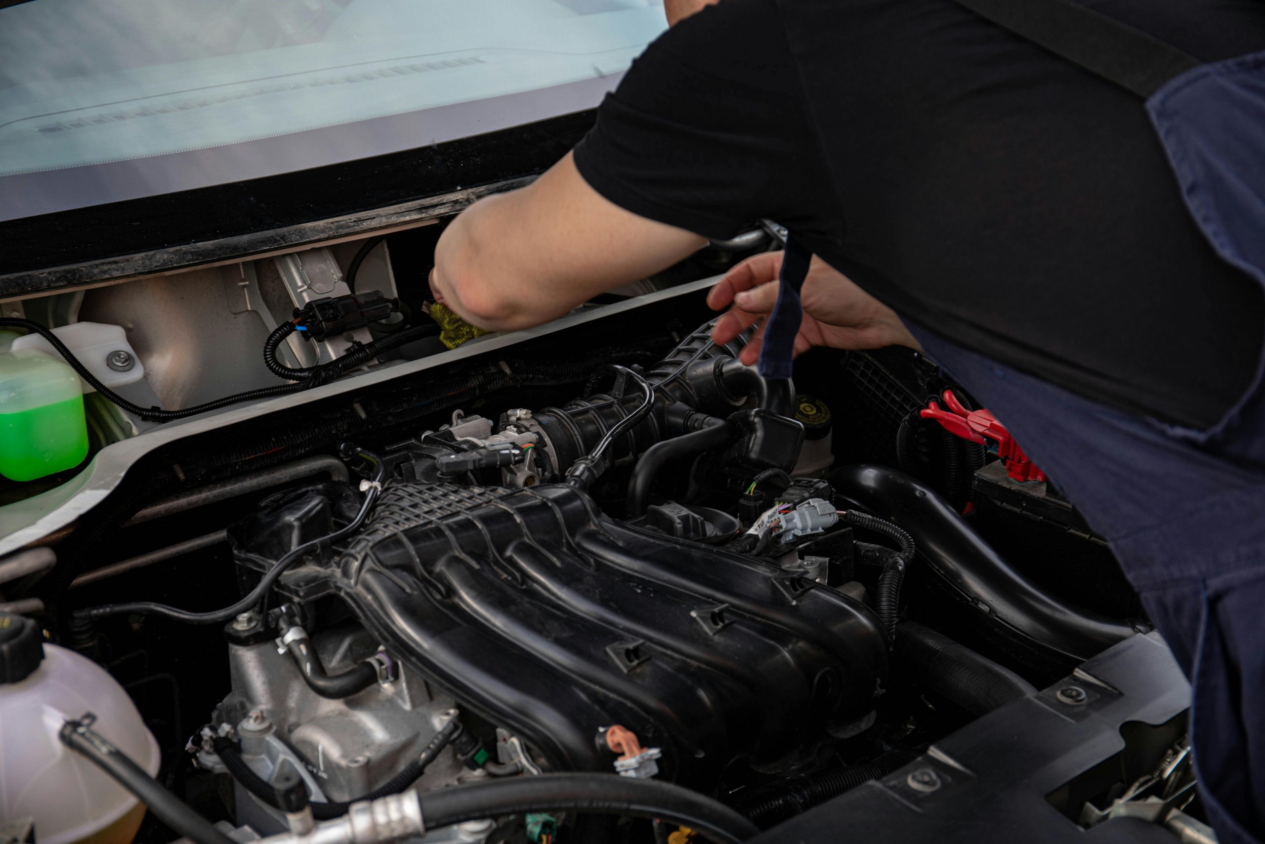 man working on a car engine